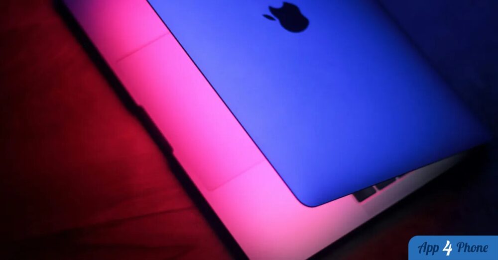 Ordinateur portable Apple éclairé par des lumières bleue et rose