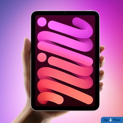 iPad tenu à la main devant un fond coloré