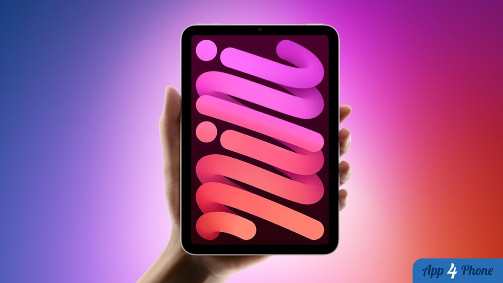 Une tablette compacte tenue en main affiche un fond d’écran coloré.
