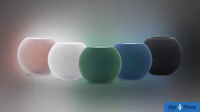 Cinq enceintes HomePod mini colorées alignées sur fond dégradé