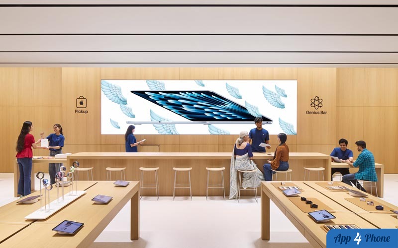 Intérieur d’un Apple Store avec tables produits et Genius Bar
