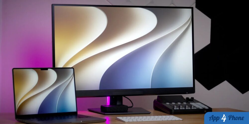 Ordinateur portable et écran affichant le fond d’écran de macOS