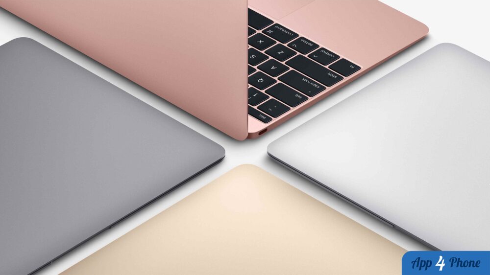 Plusieurs MacBook aux finitions colorées, dont un modèle rose ouvert