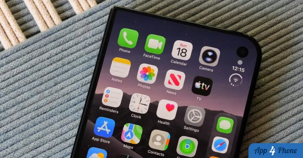 iPhone Duo affichant son écran d’accueil sur un tissu gris